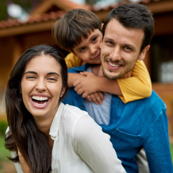 family of three smiling together