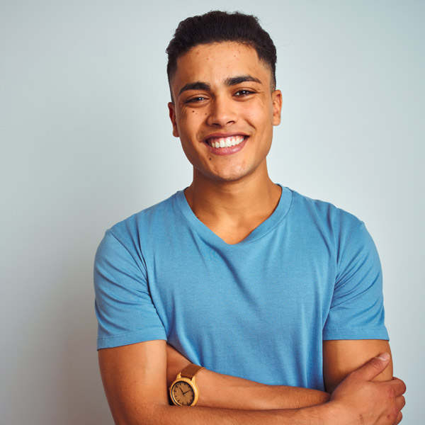 man smiling with arms crossed