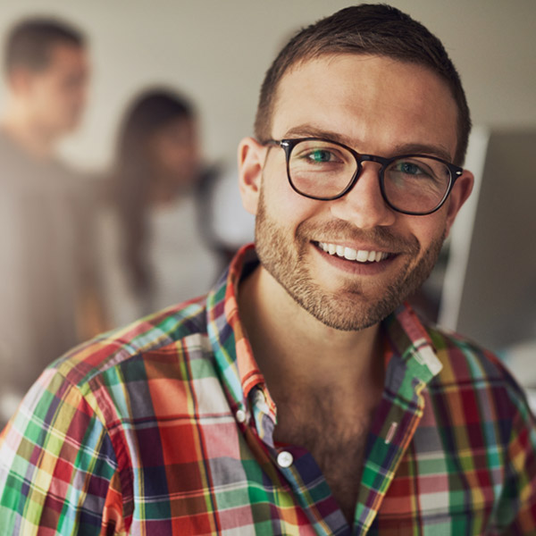 man in plaid shirt smiling