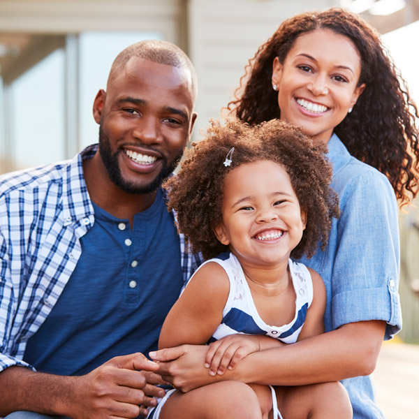 family of three smiling together